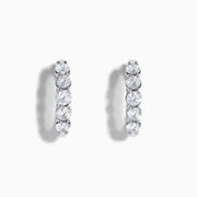 The Classique 14K White Gold Diamond Hoop Earrings feature five round diamonds on each hoop, shown against a white background for a timeless look.