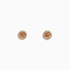 The 14K Rose Gold Brown and White Diamond Stud Earrings feature a central brown and white diamond, surrounded by a halo of clear stones, set in rose gold on a white background.