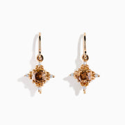 The 14K Rose Gold Brown and White Diamond Dangle Earrings feature a central brown diamond surrounded by white diamonds, each earring hanging from a simple rose gold hook.
