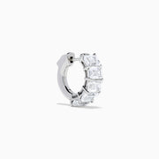 A pair of Lab Grown Emerald Cut Diamond Huggie Earrings in 14K white gold, each featuring three vertically-set rectangular clear stones, is displayed against a plain white background.