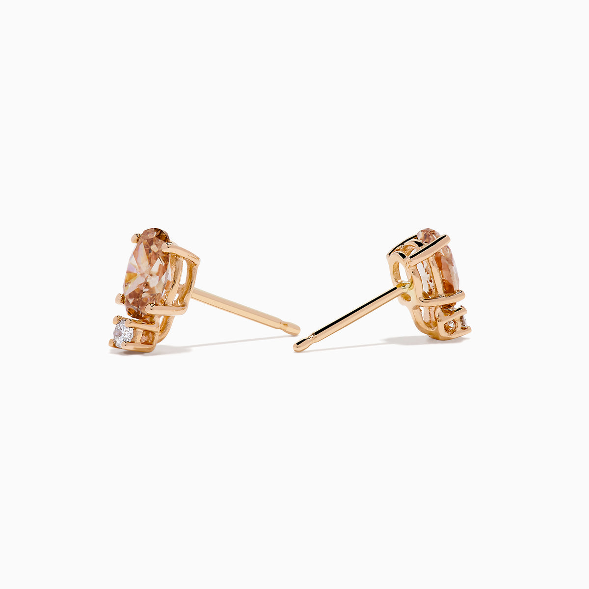 The 14K Rose Gold Brown and White Diamond Stud Earrings each feature an oval brown and white diamond above a small round gemstone, shown against a plain white background.