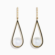 The 14K Yellow Gold Fresh Water Pearl and Diamond Drop Earrings feature teardrop-shaped open frames with a white pearl at the bottom and sparkling diamonds along the hooks for an elegant look.