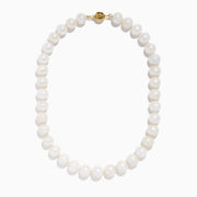 A close-up of the 14K Yellow Gold Fresh Water Pearl Necklace shows large, round freshwater pearls strung on 14K yellow gold, beautifully curved against a plain white background.