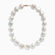 A close-up of the 14K Yellow Gold Freshwater Coin Shape Pearl Necklace, showcasing round, iridescent pearls in a partial semicircle on a white background.