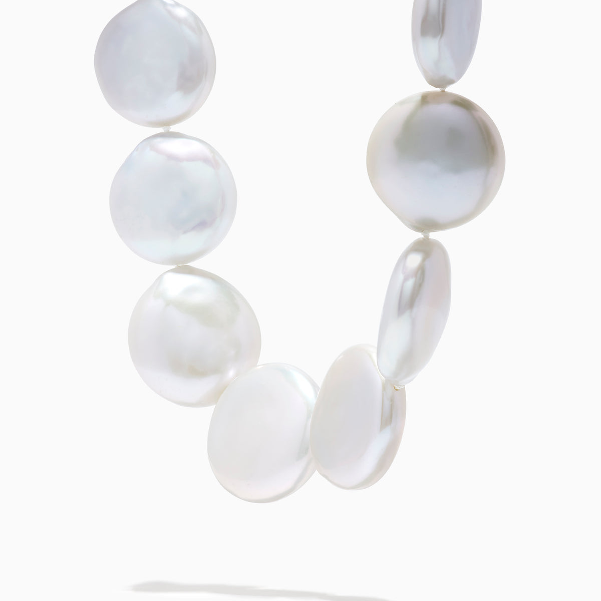 A close-up of the 14K Yellow Gold Freshwater Coin Shape Pearl Necklace, showcasing round, iridescent pearls in a partial semicircle on a white background.