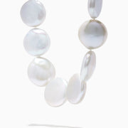 A close-up of the 14K Yellow Gold Freshwater Coin Shape Pearl Necklace, showcasing round, iridescent pearls in a partial semicircle on a white background.