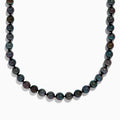 Close-up of the lower half of a 14K White Gold Tahitian Pearl Necklace, featuring round, dark pearls against a white background.