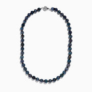 Close-up of the lower half of a 14K White Gold Tahitian Pearl Necklace, featuring round, dark pearls against a white background.