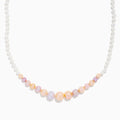 The 14K Yellow Gold Multi Color Freshwater Pearl Necklace features small white pearls graduating to larger pastel pink, peach, and lavender pearls at the center, all elegantly strung on 14K yellow gold.