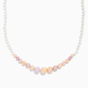 The 14K Yellow Gold Multi Color Freshwater Pearl Necklace features small white pearls graduating to larger pastel pink, peach, and lavender pearls at the center, all elegantly strung on 14K yellow gold.