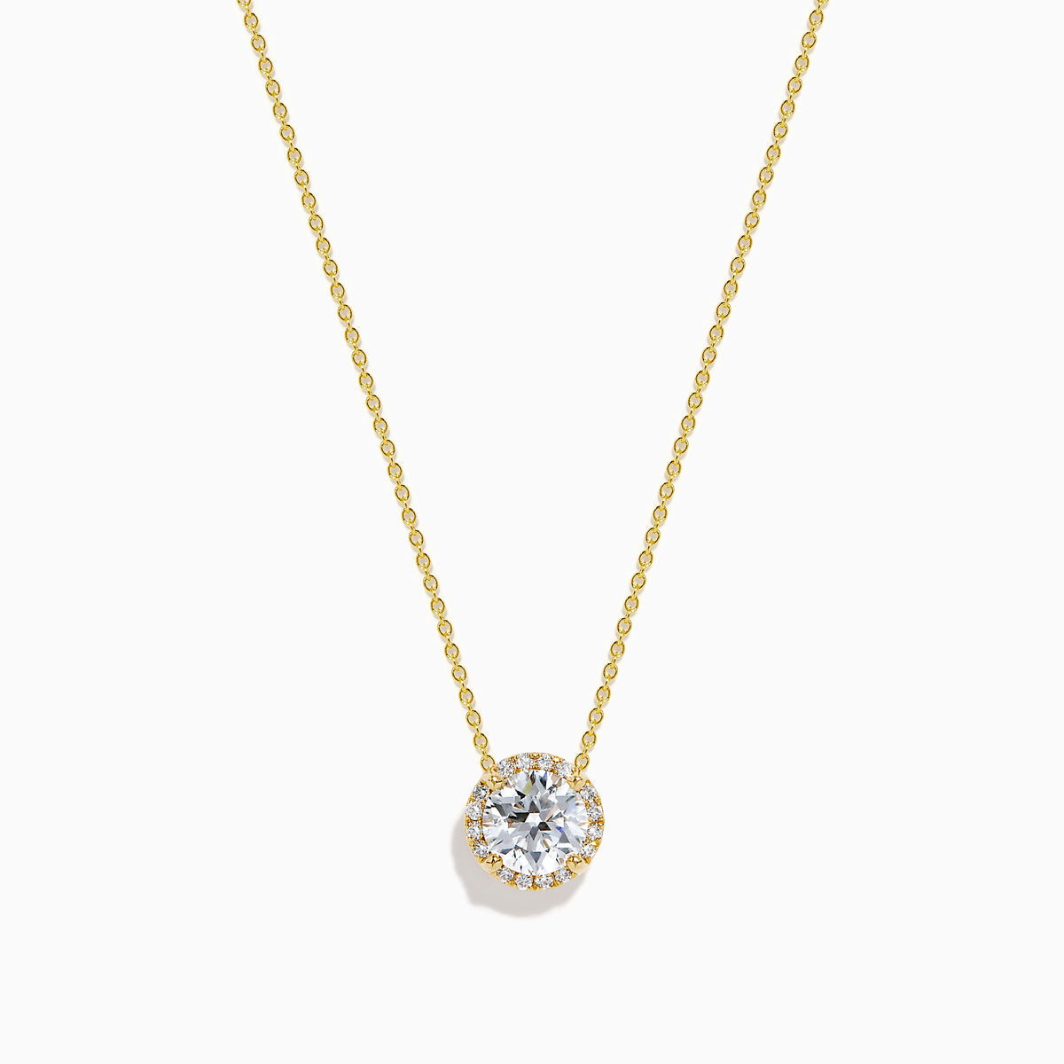 The Star Lab Grown Diamond Halo Pendant in 18K Yellow Gold features a round brilliant lab diamond surrounded by smaller diamonds on a gold chain, displayed against a plain white background.