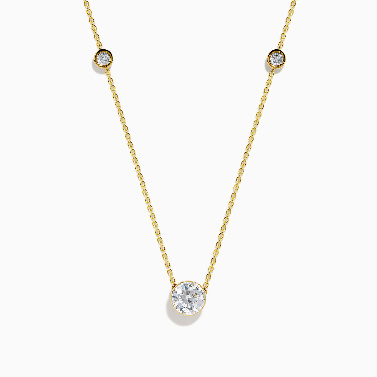 The Star Lab Grown Diamond Necklace in 18K Yellow Gold features a delicate chain with three round, bezel-set diamonds—a larger center diamond and two smaller diamonds evenly spaced along the chain.