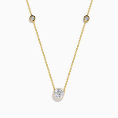 The Star Lab Grown Diamond Necklace in 18K Yellow Gold features a delicate chain with three round, bezel-set diamonds—a larger center diamond and two smaller diamonds evenly spaced along the chain.