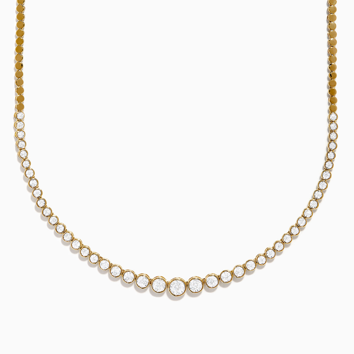 The 14K Yellow Gold Graduated Diamond Tennis Necklace showcases round diamonds set closely together, featuring larger center stones that gradually taper to smaller ones at the ends.