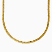 A close-up image of the Mens 14K Yellow Gold 20 Solid Cuban Domed Chain, featuring a flat, intricate link pattern and displayed in a U-shape against a plain white background.
