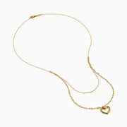 Two gold necklaces are shown: a delicate 14K yellow gold chain and the 14K Yellow Gold Stamp Heart Layered Paperclip Necklace, which features larger links and a heart-shaped pendant. Both pieces are displayed on a plain white background.