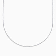 The 14K White Gold Bead Necklace is displayed on a white background, its delicate form creating a graceful curve.