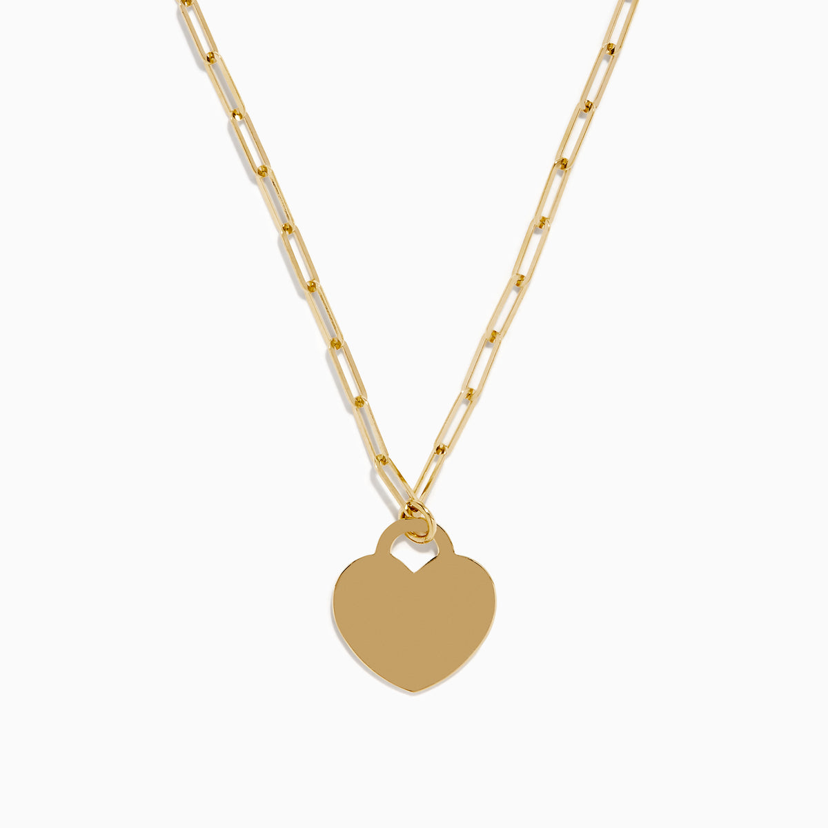The 14K Yellow Gold Heart on a Paperclip Chain Necklace features an elongated chain and a flat heart pendant, elegantly displayed on a white background.