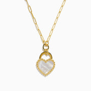 The 14K Yellow Gold Mother of Pearl Heart Pendant features a paperclip-style gold chain and a heart-shaped pendant with a pearly white center and beaded gold border.