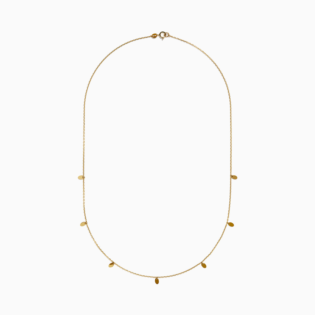 The 14K Yellow Gold Oval Charm Station Necklace features small, evenly spaced oval-shaped charms that hang gracefully along the lower half of a delicate yellow gold chain.