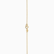 The 14K Yellow Gold Oval Charm Station Necklace features small, evenly spaced oval-shaped charms that hang gracefully along the lower half of a delicate yellow gold chain.