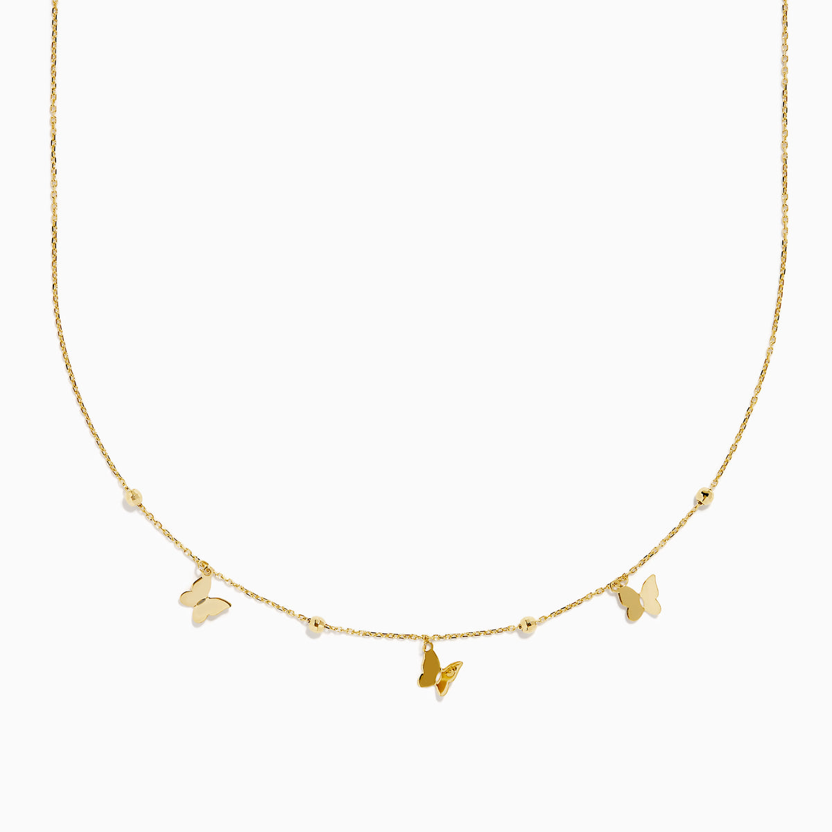 The 14K Yellow Gold Butterfly Station Necklace features three butterfly charms and four round beads evenly spaced along a delicate chain.