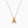 The 14K Yellow Gold Initial A Bubble Pendant is a gold chain necklace with a polished A pendant, shown on a plain white background.