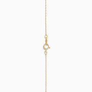 The 14K Yellow Gold Initial B Bubble Pendant shines on a delicate gold chain, displayed against a white background.