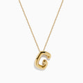The 14K Yellow Gold Initial G Bubble Pendant is showcased on a delicate chain against a plain white background.