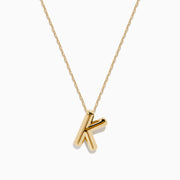 The 14K Yellow Gold Initial K Bubble Pendant features a bubble design initial on a delicate chain, shown against a plain white background.