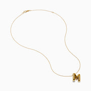 The 14K Yellow Gold Initial M Bubble Pendant is displayed on a thin chain against a plain white background.