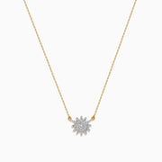 The D'Oro 14K Yellow Gold Diamond Sunburst Collarbone Necklace showcases a sun-shaped pendant adorned with sparkling white diamonds, elegantly displayed on a plain white background.