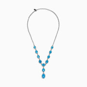 A close-up of the Ocean Bleu 14K White Gold Blue Topaz and Diamond Lavaliere Necklace featuring three oval blue topaz gemstones and diamonds in a vertical drop pendant, shown against a plain white background.