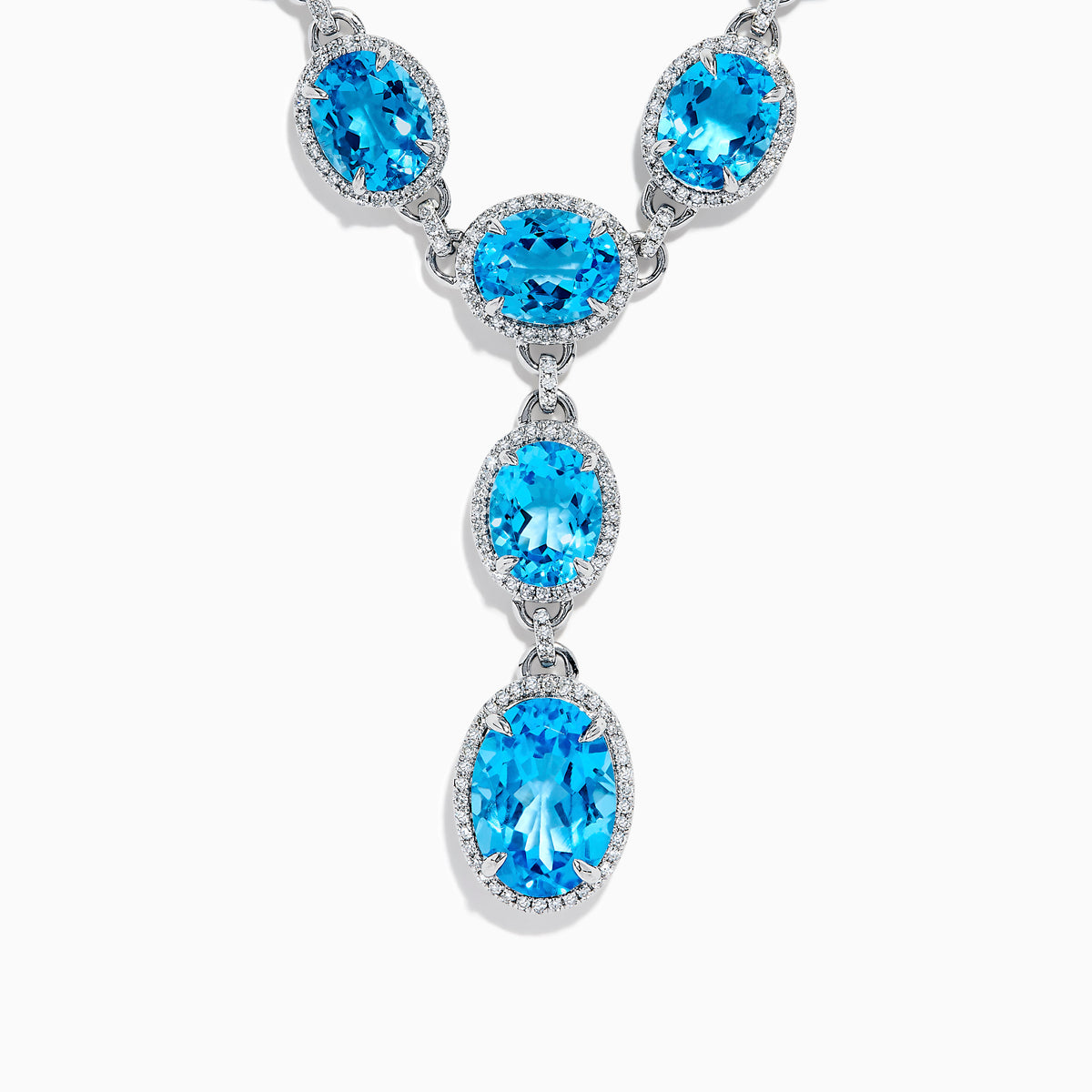 A close-up of the Ocean Bleu 14K White Gold Blue Topaz and Diamond Lavaliere Necklace featuring three oval blue topaz gemstones and diamonds in a vertical drop pendant, shown against a plain white background.