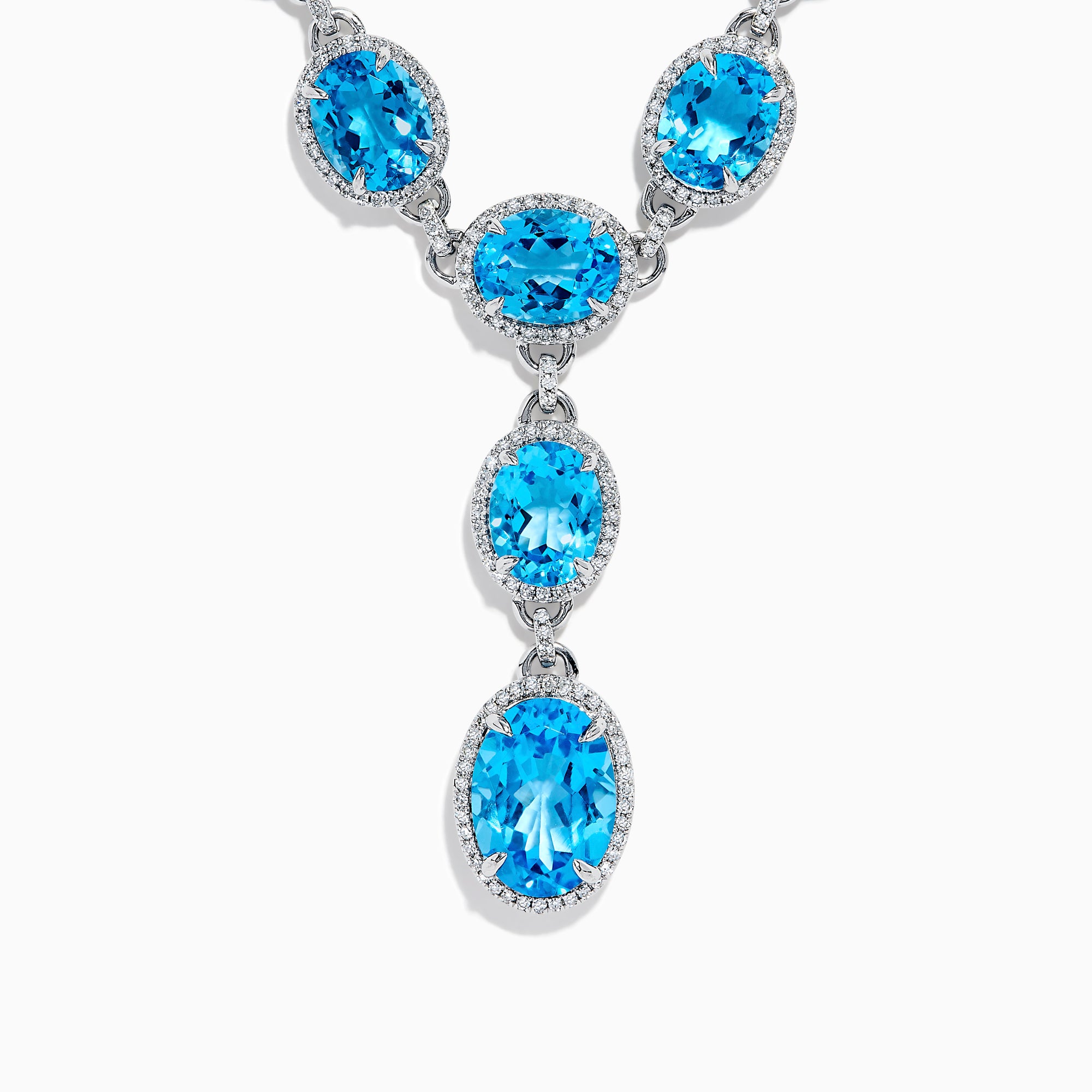 A close-up of the Ocean Bleu 14K White Gold Blue Topaz and Diamond Lavaliere Necklace featuring three oval blue topaz gemstones and diamonds in a vertical drop pendant, shown against a plain white background.