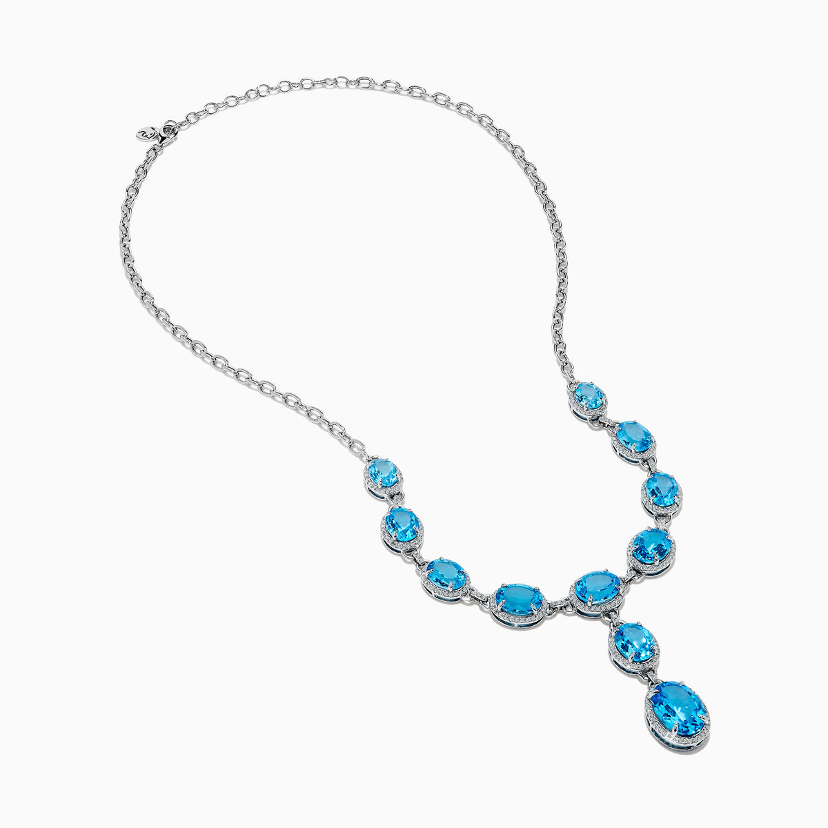 A close-up of the Ocean Bleu 14K White Gold Blue Topaz and Diamond Lavaliere Necklace featuring three oval blue topaz gemstones and diamonds in a vertical drop pendant, shown against a plain white background.