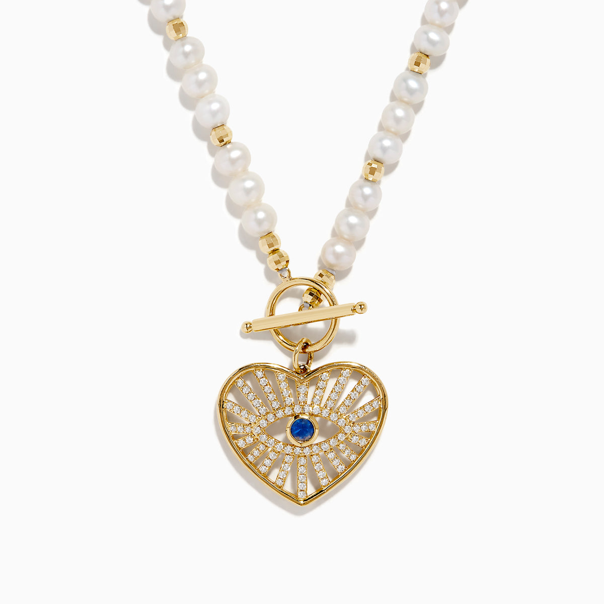 The 14K Yellow Gold Fresh Water Pearl Sapphire and Diamond Necklace features beaded pearls, a toggle clasp, and a heart-shaped gold pendant with an eye design set with diamonds and a central sapphire.