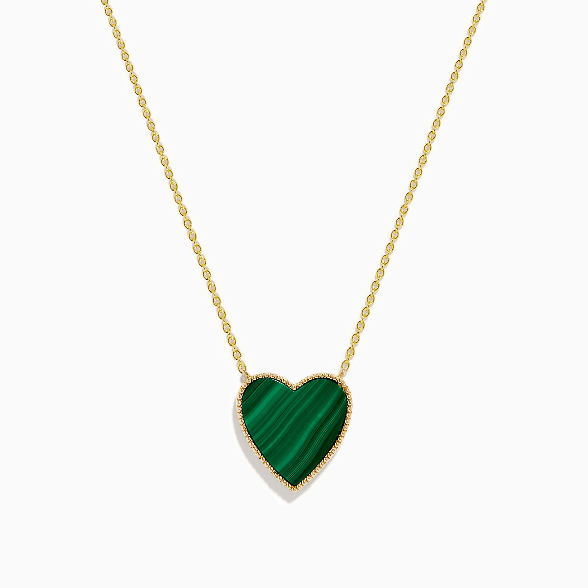 The 14K Gold Malachite and Diamond Reversible Heart Necklace showcases a large, heart-shaped malachite pendant with a smooth finish and delicate gold border.