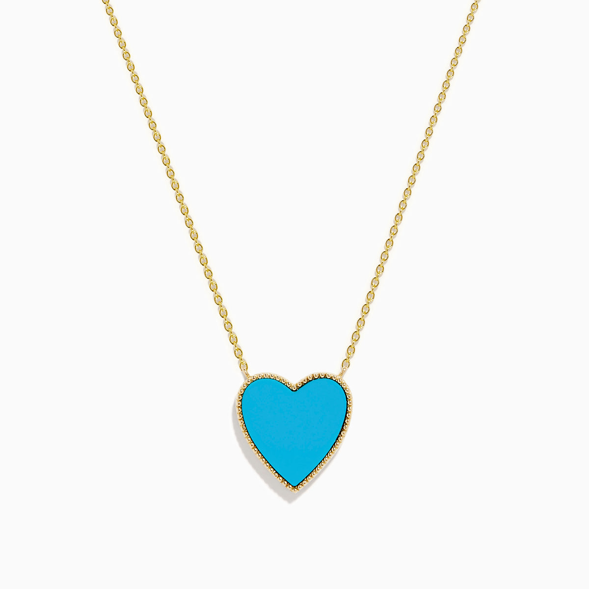 The 14K Gold Turquoise and Diamond Reversible Heart Necklace showcases a bold turquoise heart pendant framed in gold, displayed on a white background.