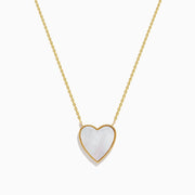 14K Gold Mother of Pearl and Diamond Reversible Heart Necklace featuring a large heart-shaped pendant with gold detailing, shown on a plain white background.