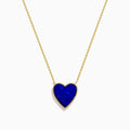 The 14K Gold Lapis Lazuli and Diamond Reversible Heart Necklace features a blue lapis lazuli heart pendant with a gold border, displayed against a white background.