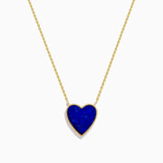 The 14K Gold Lapis Lazuli and Diamond Reversible Heart Necklace features a blue lapis lazuli heart pendant with a gold border, displayed against a white background.