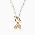 The 14K Yellow Gold Fresh Water Pearl and Diamond Evil Eye Necklace features pearl beads, a gold toggle clasp, and two gold charms: a black-centered eye and a hand encrusted with diamond-like stones.