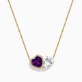 The 14K Yellow Gold Amethyst, White Topaz, and Diamond Necklace features two heart pendants: an amethyst surrounded by diamonds and a white topaz, both elegantly hanging side by side.