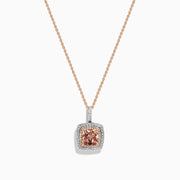 The 14K Two Tone Gold Morganite and Diamond Pendant features a cushion-cut peach morganite surrounded by sparkling diamonds, set in a blend of rose and white gold for an elegant, refined look.