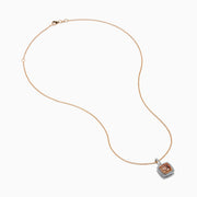 The 14K Two Tone Gold Morganite and Diamond Pendant features a cushion-cut peach morganite surrounded by sparkling diamonds, set in a blend of rose and white gold for an elegant, refined look.