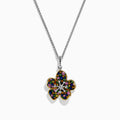 The Splash Sterling Silver Diamond, Sapphires & Tsavorite Flower Necklace features a silver chain with a flower pendant edged in gold, adorned with vibrant sapphires and tsavorite on each petal, and a sparkling diamond at the center.