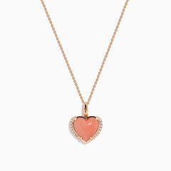 The 14K Rose Gold Pink Opal and Diamond Heart Pendant features a pink opal heart accented with sparkling diamonds on a rose gold chain.