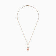 The Blush 14K Rose Gold Morganite and Diamond Pendant features a pear-shaped morganite framed by a halo of white diamonds on a delicate rose gold chain.