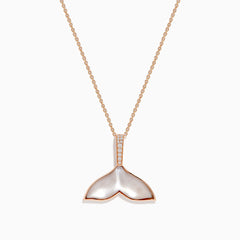 The Seaside 14K Gold Pendant features a whale’s tail design with mother-of-pearl inlay, sparkling diamonds on the bail, and a touch of quartz crystal for added elegance.